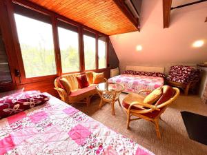 a bedroom with two beds and a table and chairs at Best of Ilidza and Rakovica holiday HOME in Sarajevo