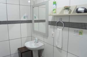 a white bathroom with a sink and a mirror at Hospedagem Da Laranjeira Gramado in Gramado +96 photos