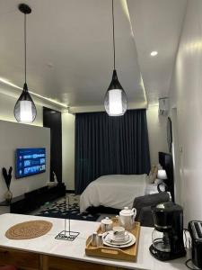 a room with a bedroom with a bed and a desk at MCM _Haven in Dar es Salaam