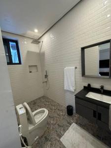 a bathroom with a toilet and a sink at MCM _Haven in Dar es Salaam +13 photos