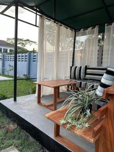 a patio with a picnic table and a bench at MCM _Haven in Dar es Salaam
