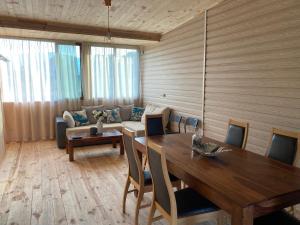 a dining room with a table and a couch at Villa Sea Dreams in Chernomorets