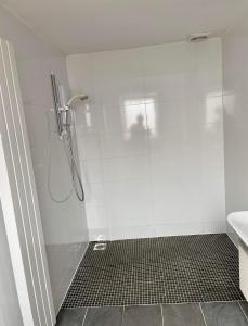 a shower with a glass door in a bathroom at Adina s House in Rugeley +17 photos