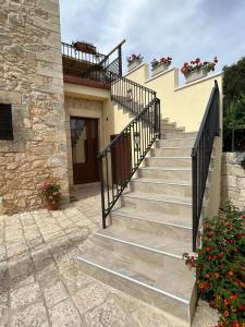 un conjunto de escaleras que conducen a una casa con flores en Borgo Monachella, en Ragusa