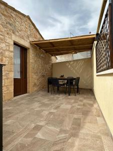 a patio with a table and chairs on it at Borgo Monachella in Ragusa