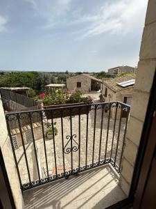 a balcony with a view of a yard at Borgo Monachella in Ragusa