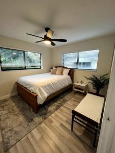a bedroom with a bed and a ceiling fan at Modern Tropical Oasis with Arcade, HotTub & MiniGolf in Hollywood