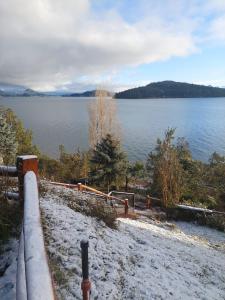 a view of a lake with snow on the ground at Destinar Apartments in San Carlos de Bariloche