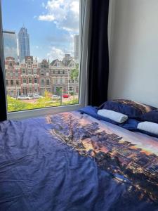 1 cama con vistas a la ciudad desde una ventana en MyCityLofts, en Róterdam