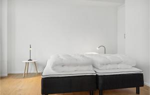 a pile of white towels sitting on top of a bed at 2 Bedroom Lovely Apartment In Aarhus C in Aarhus