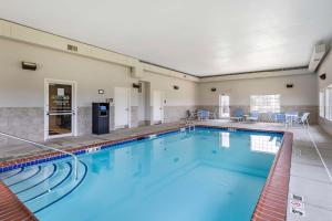 a large swimming pool with blue water in a building at Best Western Plus MidAmerica Hotel in Mascoutah