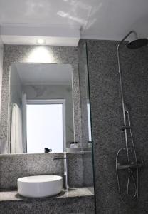 a bathroom with a bath tub and a mirror at Fiosal Apartments 2 in Skiathos Town