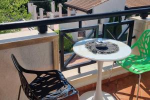 a table and two chairs on a balcony at Oazis resort lux vip apartament in Lozenets