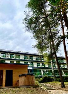 a building with a wooden barrel in front of it at Apartament nad Zalewem Zegrzyńskim in Serock