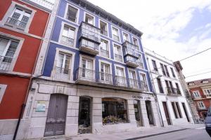 a building on a street with a store at 10C02 Moderno ático en Pravia in Pravia