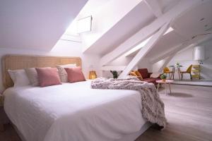 a bedroom with a large white bed in a attic at 10C02 Moderno ático en Pravia in Pravia