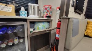 a refrigerator with a fire extinguisher in a room at The River RV in Smithville