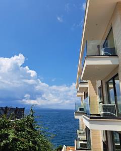 a building with a view of the ocean at Mamani Apartments Saranda in Sarandë