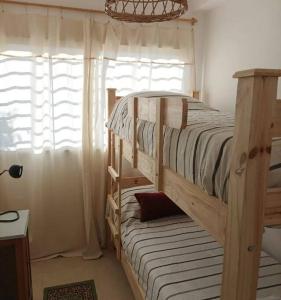 a bedroom with a bunk bed and a window at Las Higueritas1 in San Juan