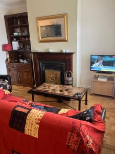 a living room with a couch and a fireplace at 27 Cill Ard Bohermore galway in Galway