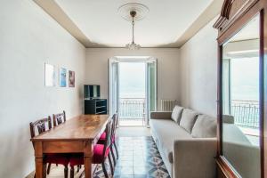 a living room with a couch and a table at Da Flora Wonderful Lakefront View in Colonno
