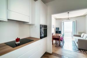 a kitchen and living room with a couch and a table at Da Flora Wonderful Lakefront View in Colonno +13 photos