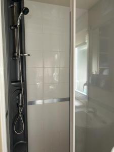 a shower with a glass door in a bathroom at Ralph’s Retreat in Cottam