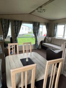 a living room with a table and chairs and a couch at Ralph’s Retreat in Cottam