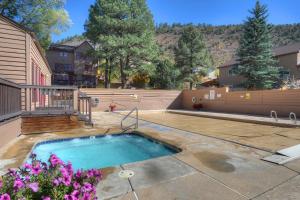 a small swimming pool in a yard with flowers at 2 2 Ferringway 13 in Durango