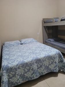 a bedroom with a bed with a blue comforter at Casa Temporada Nosso Recanto Piscina aquecimento Solar in Olímpia