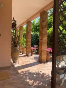 a patio with potted plants and a staircase at Casa Rosati - Baia Flaminia in Pesaro