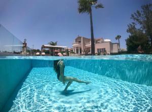 a statue of a mermaid in a swimming pool at Villa Damant in Pithárion