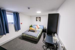 a living room with a couch and a table at Maidstone High St - Deluxe Ensuite Rooms - Fast Wi-Fi in Kent