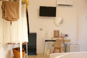 a bedroom with a bed and a desk with a mirror at TORRE VECCHIA RELAIS in Ugento