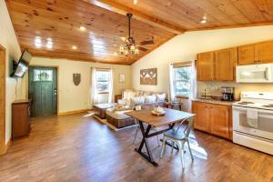 a kitchen and living room with a table and a couch at *New Owner Special* Cozy Cabin with mountain views in Robbinsville