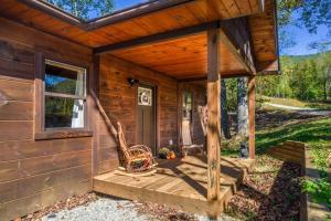 a cabin with a porch and a porch swing at *New Owner Special* Cozy Cabin with mountain views in Robbinsville