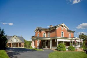 a large red brick house with a driveway at Peaceful Easy Feelings - King Sized Bed - Sleeps 2 in Lynchburg