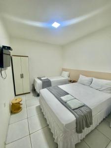 En eller flere senge i et værelse på Pousada Girassol