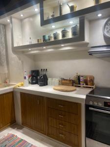 a kitchen with wooden cabinets and a counter top at MOLYVOS BOUTIQUE HOUSE in Mythimna