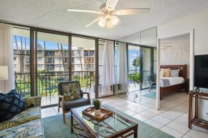 a living room with a couch and a tv at Kanai A Nalu 214 in Wailuku