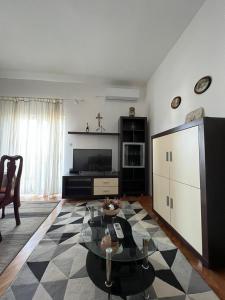 a living room with a table and a tv at Apartments with a parking space Kastel Sucurac, Kastela - 21585 in Kastel Sucurac