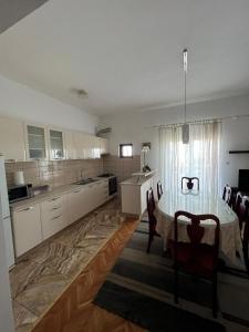 a kitchen with a table and chairs in a room at Apartments with a parking space Kastel Sucurac, Kastela - 21585 in Kastel Sucurac