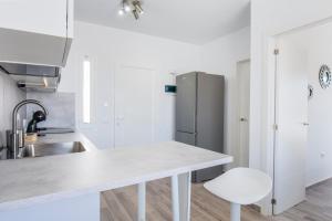 a kitchen with a sink and a refrigerator at Miramar in Tarajalejo