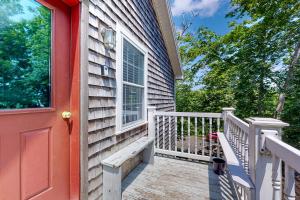 a house with a red door and a balcony at Island Time in Vineyard Haven