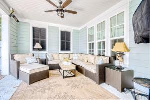 a screened in porch with a couch and chairs at Barefoot Livin' in Myrtle Beach