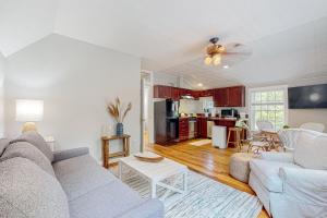 a living room with a couch and a kitchen at Island Time in Vineyard Haven