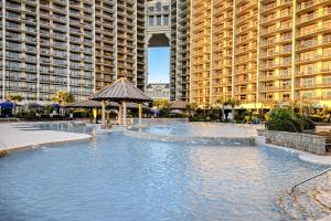 a swimming pool in front of a large building at Barefoot Livin' in Myrtle Beach