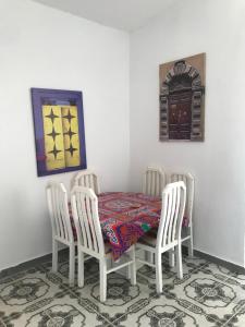 a dining room with a table and four chairs at شالية صف اول على البحر فى قرية الكرمة سيدى عبد الرحمن in El Alamein