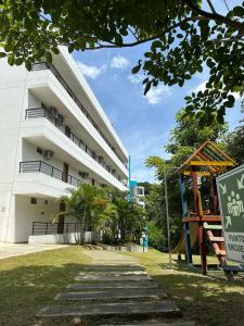 a building with a playground in front of it at Casa Paraíso in San Jerónimo