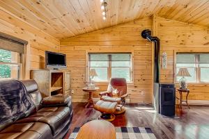 a living room with a couch and a television in a cabin at Secluded Haven - Entire House in Wevertown